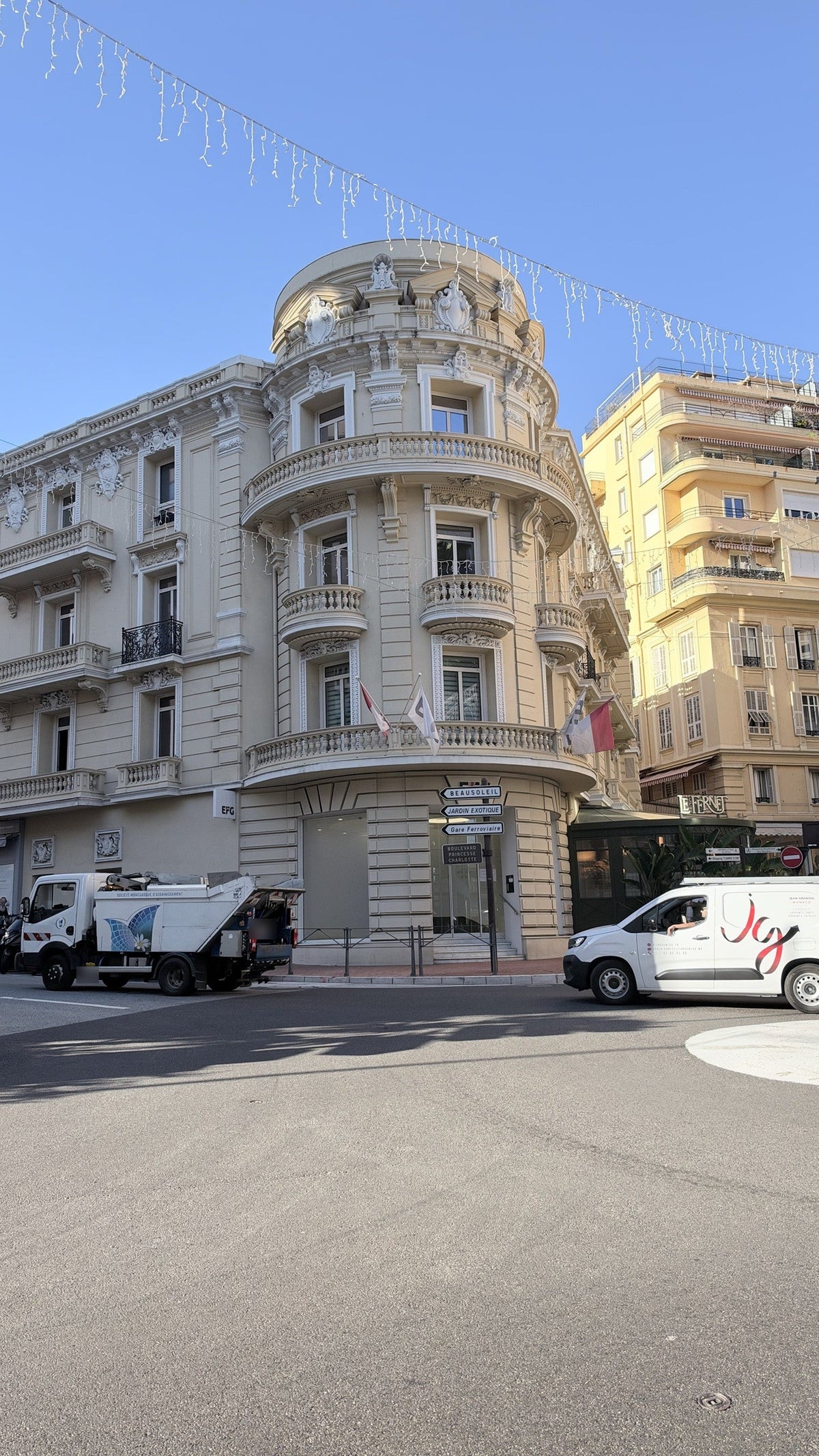 Belle Époque corner building on Boulevard Princesse Charlotte in Monaco, with road signs to Beausoleil and Jardin Exotique