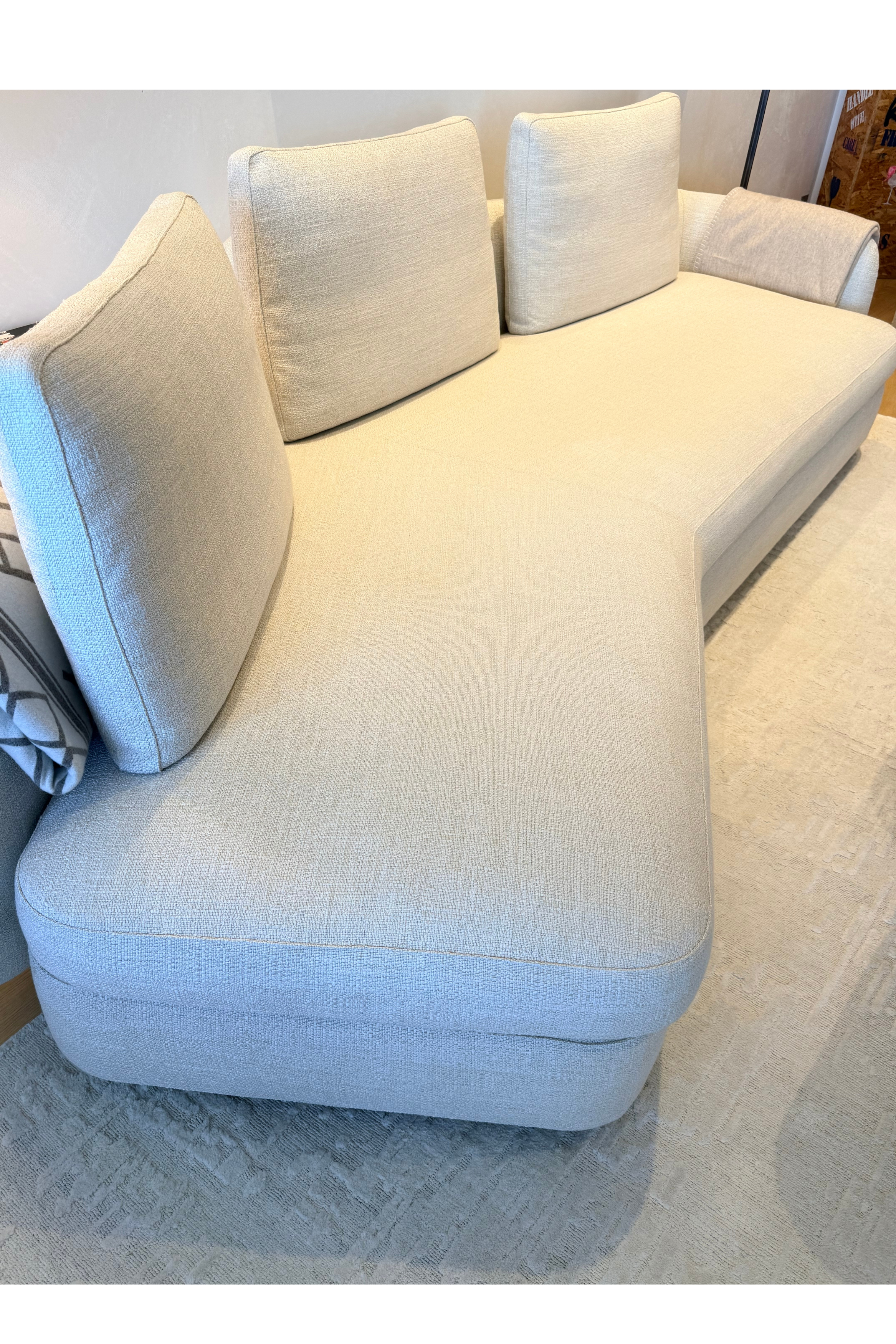 Cream Poliform sofa by Alexia Brianti, modern canape with plush cushions and sleek design in a contemporary living room.