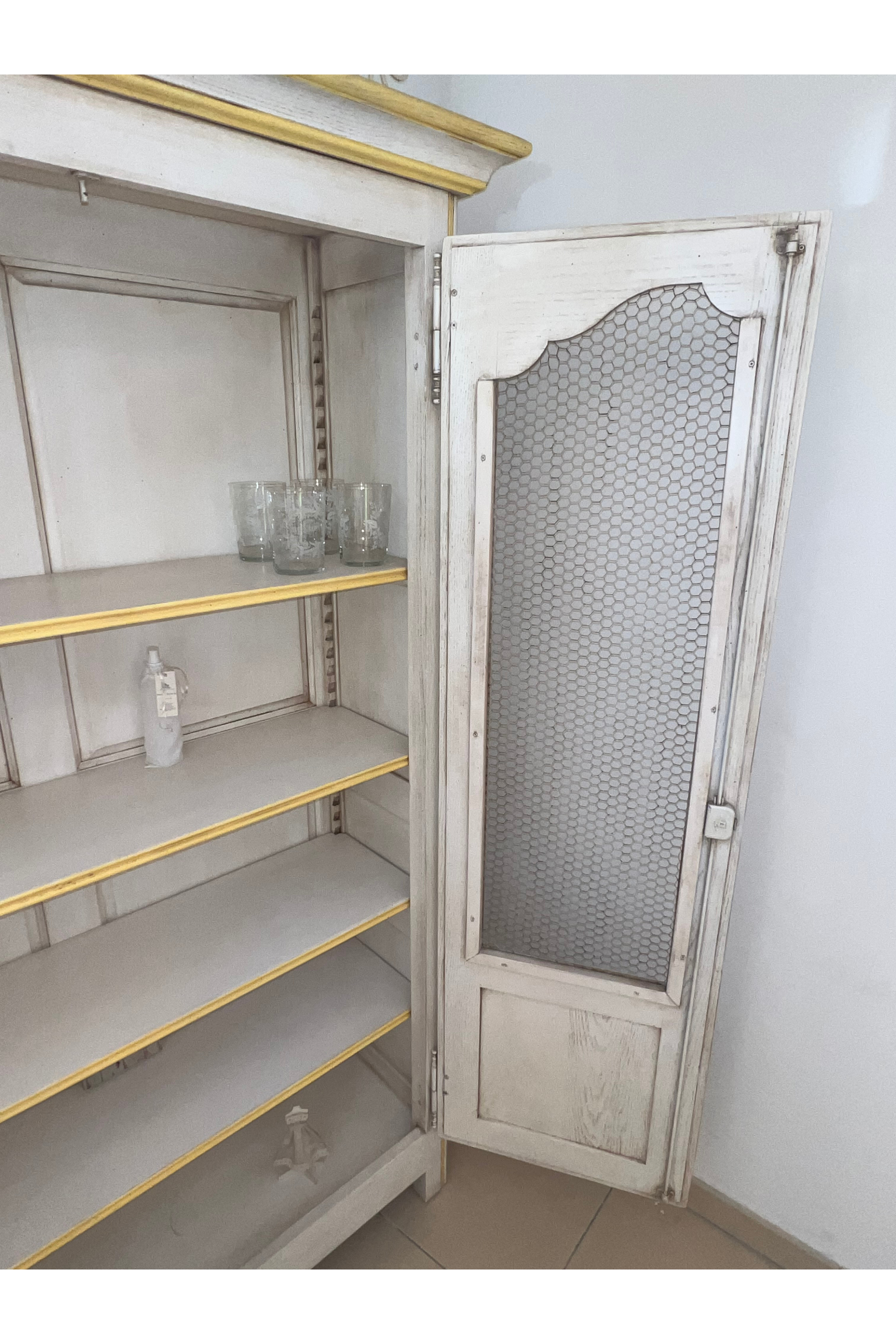 Luca Orrù shabby-chic Provençal style display cabinet with glass doors and distressed finish, showcasing vintage-inspired furniture design.