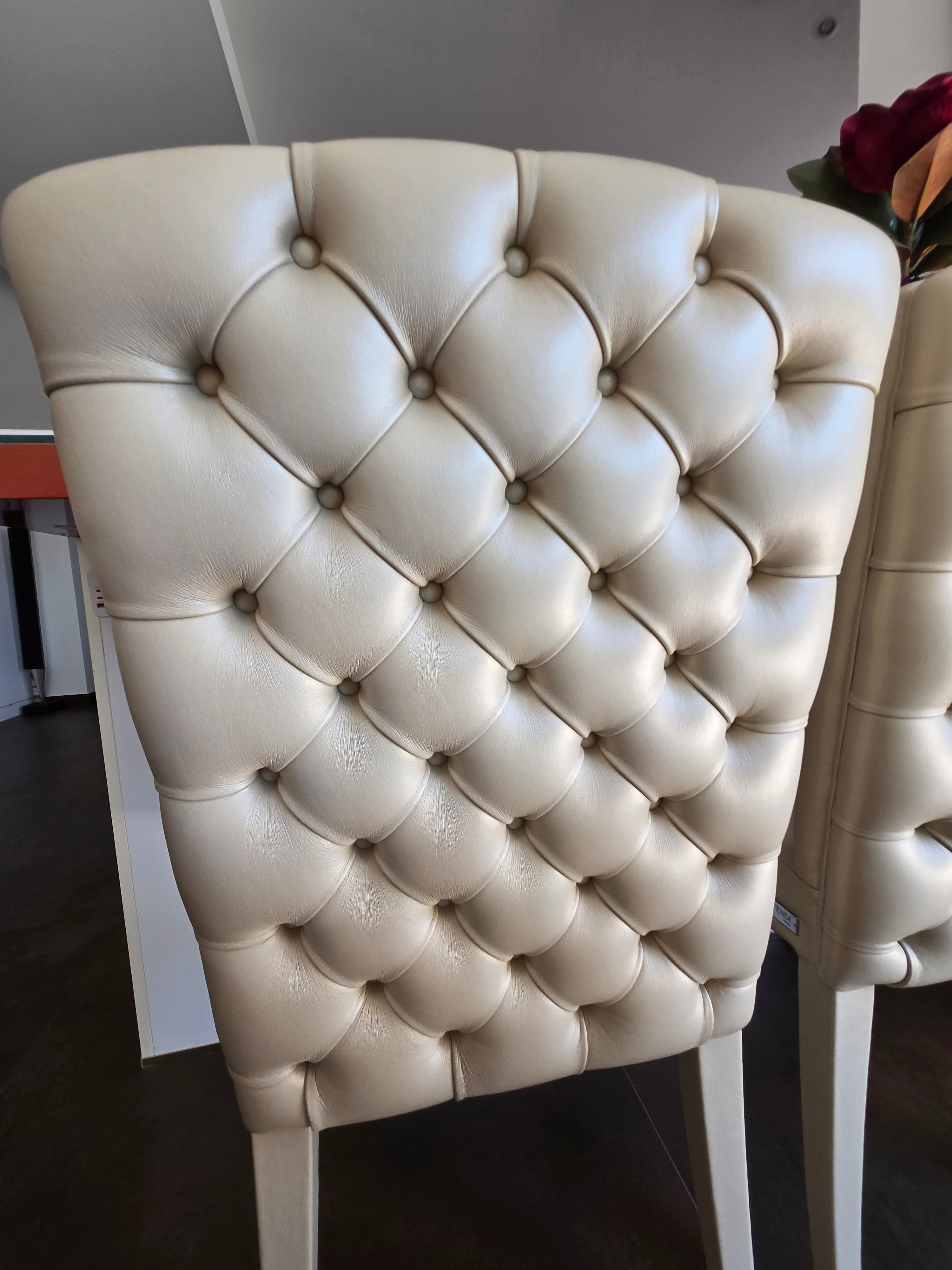 Marina Fogg Fendi Casa dining table with eight matching chairs, modern wood design, and sleek seating arrangement.
