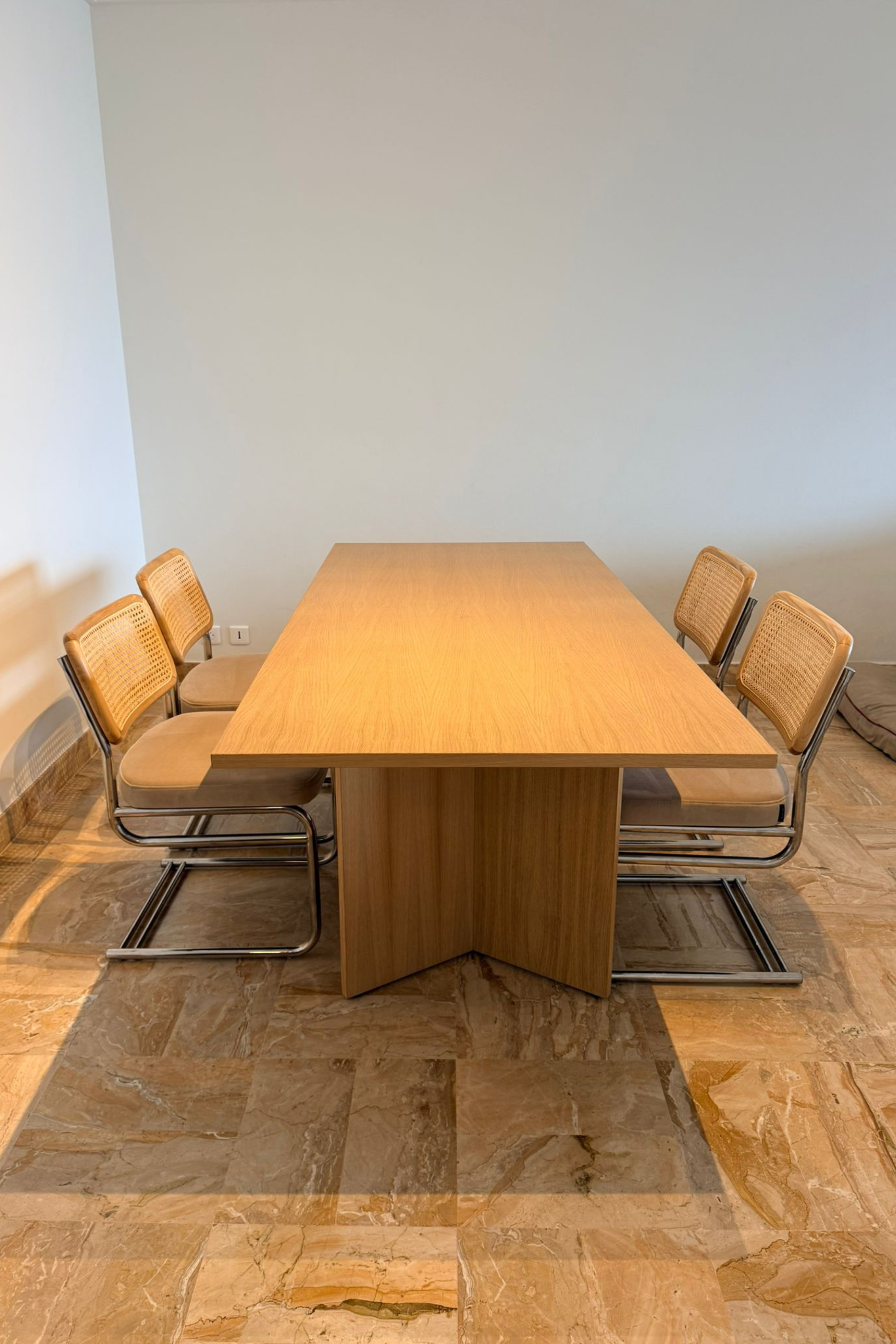Wood veneer dining table by Charlotte Isackson featuring a sleek rectangular design with a polished wood finish.