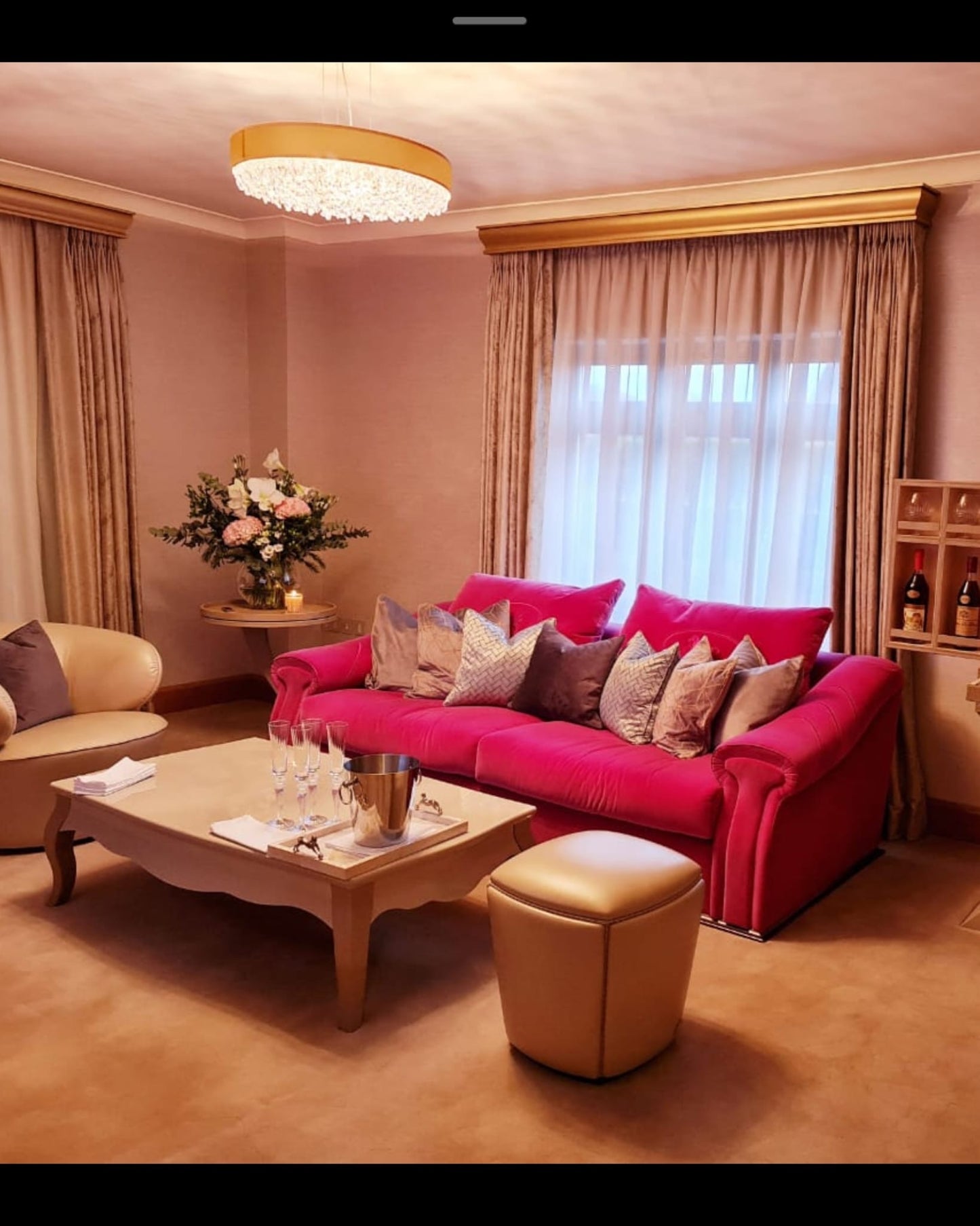 Pink Fendi Casa velvet sofa with plush cushions, modern design, and sleek legs, styled as a statement piece in a contemporary living room.
