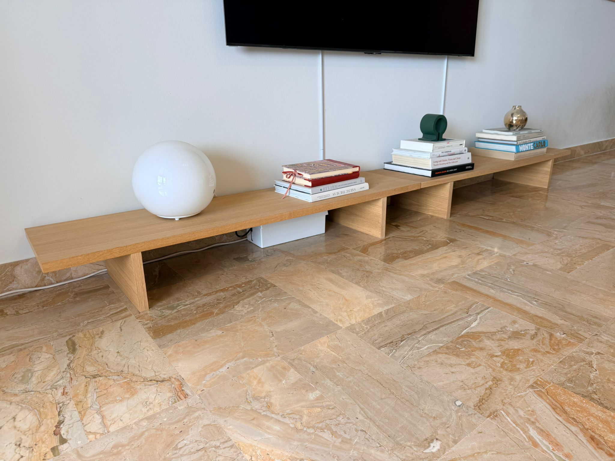 Set of two Ferm Living oak console tables or benches with sleek, modern design and smooth wooden surfaces.