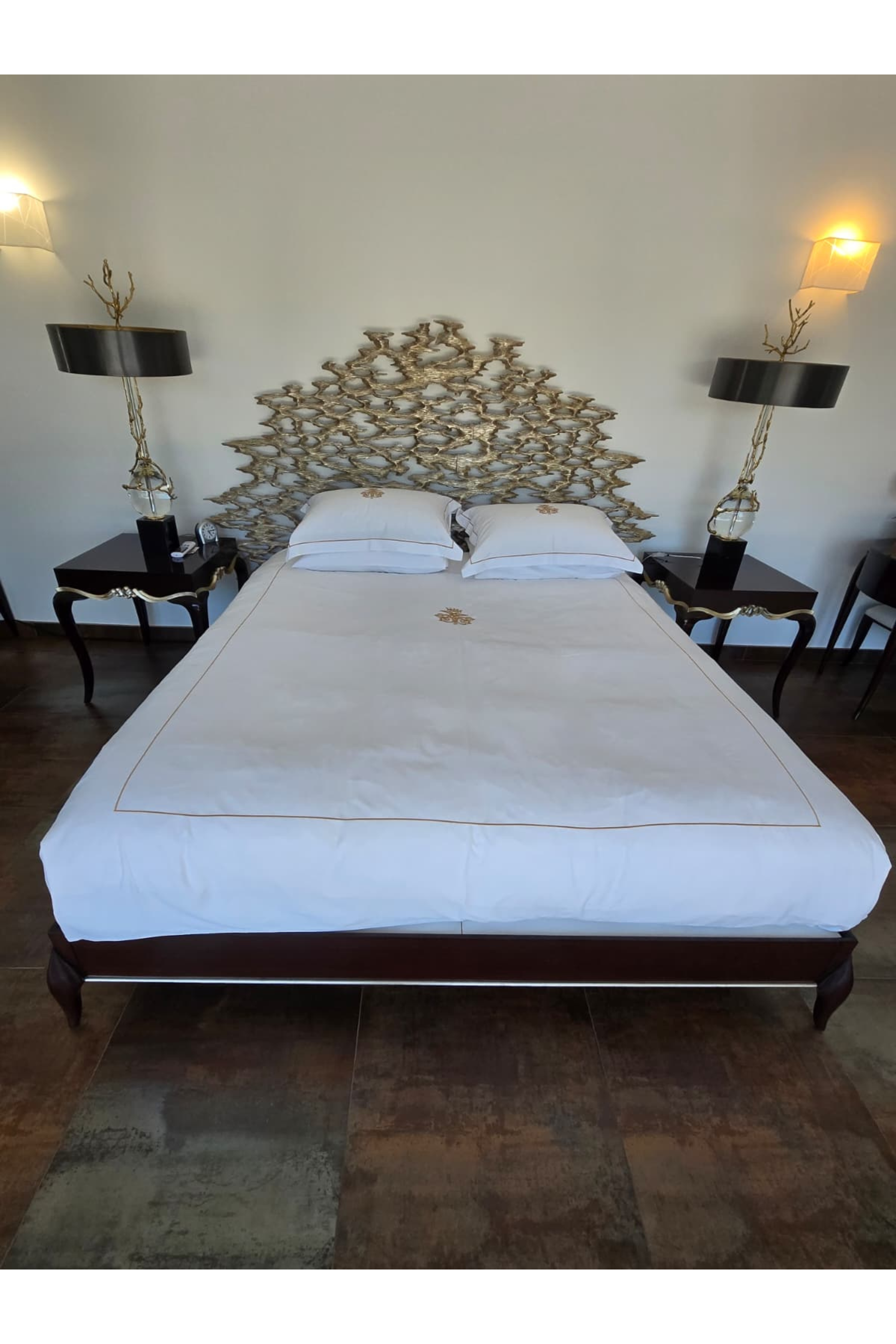 Christopher Guy Super King Bed with sculptural headboard, showcasing elegant design and luxurious fabric upholstery.