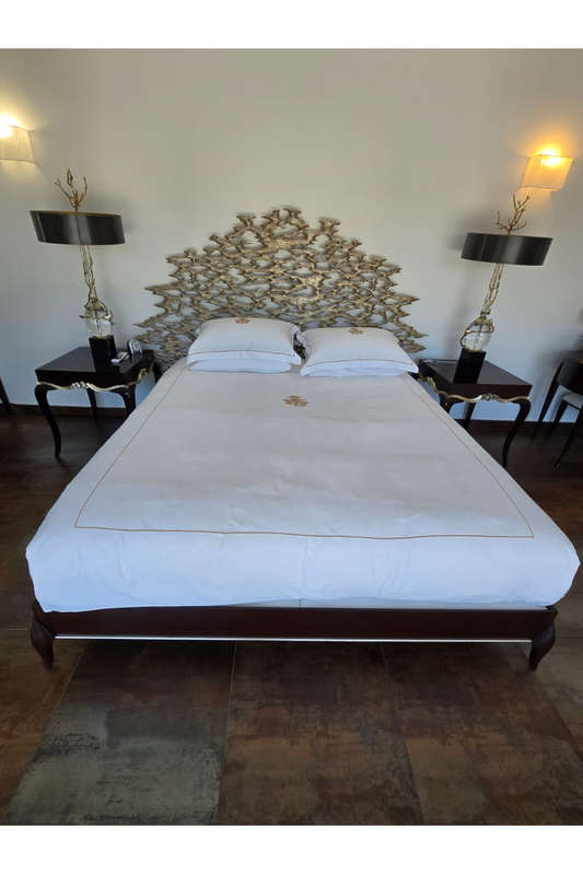 Christopher Guy Super King Bed with sculptural headboard, showcasing elegant design and luxurious fabric upholstery.