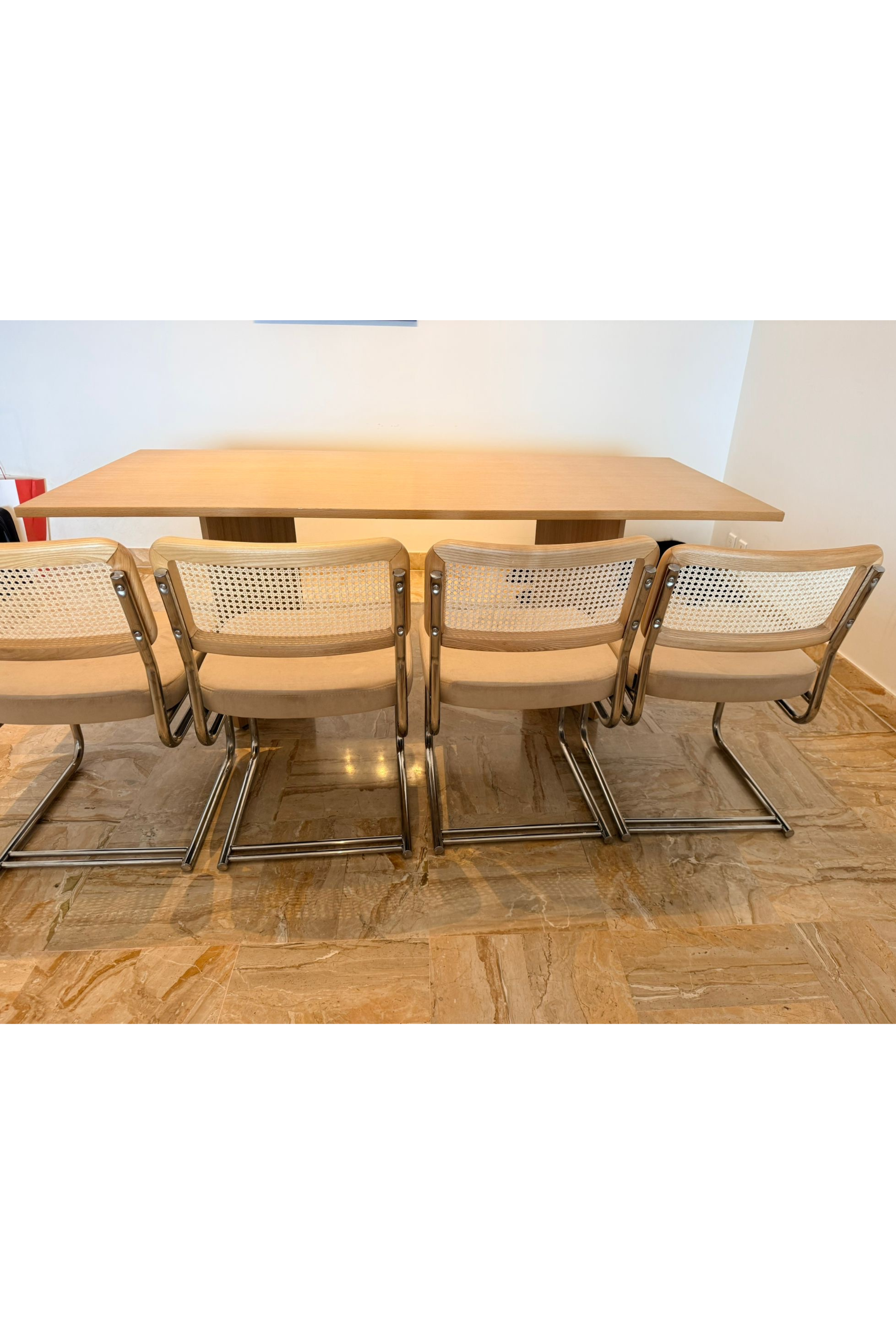 Set of four Bauhaus-style dining chairs by Charlotte Isackson, featuring sleek wooden frames and minimalist design.