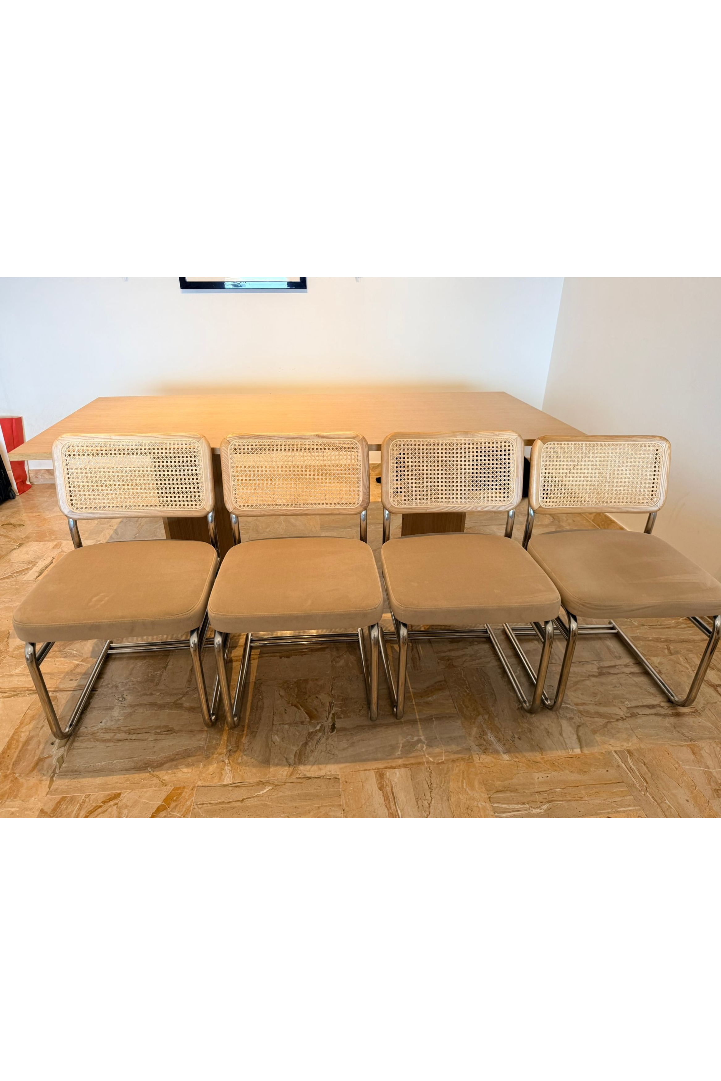 Set of four Bauhaus-style dining chairs by Charlotte Isackson featuring sleek, modern design with wooden frames and minimalist aesthetic.