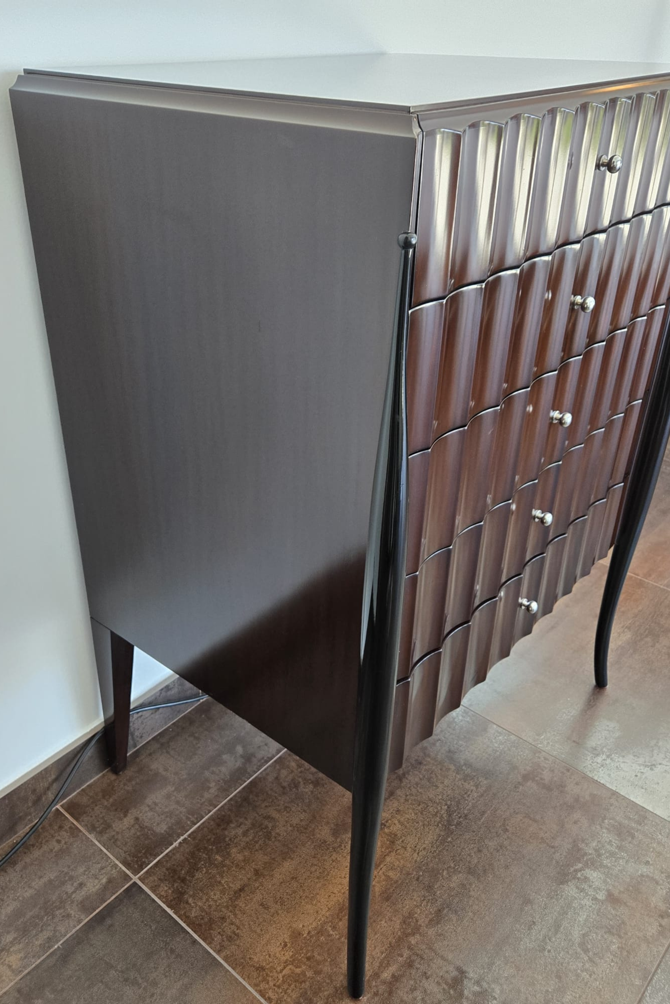 Marina Fogg Allegra sculptural chest of drawers with a curved wood front and statement design, showcasing modern furniture craftsmanship.