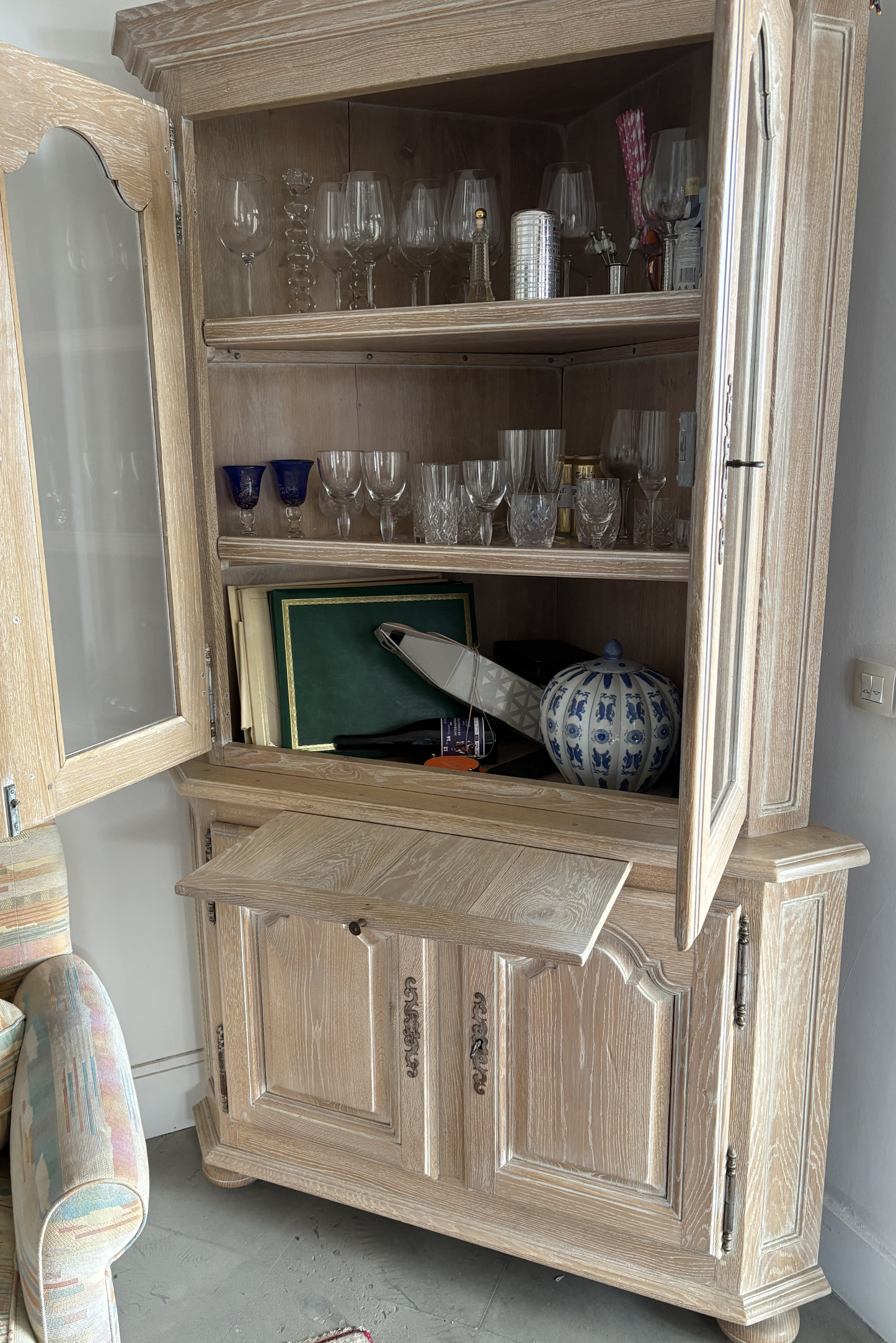 Solid ash corner drinks cabinet by Frances Bilham showcasing glass doors and interior shelving for display and storage.