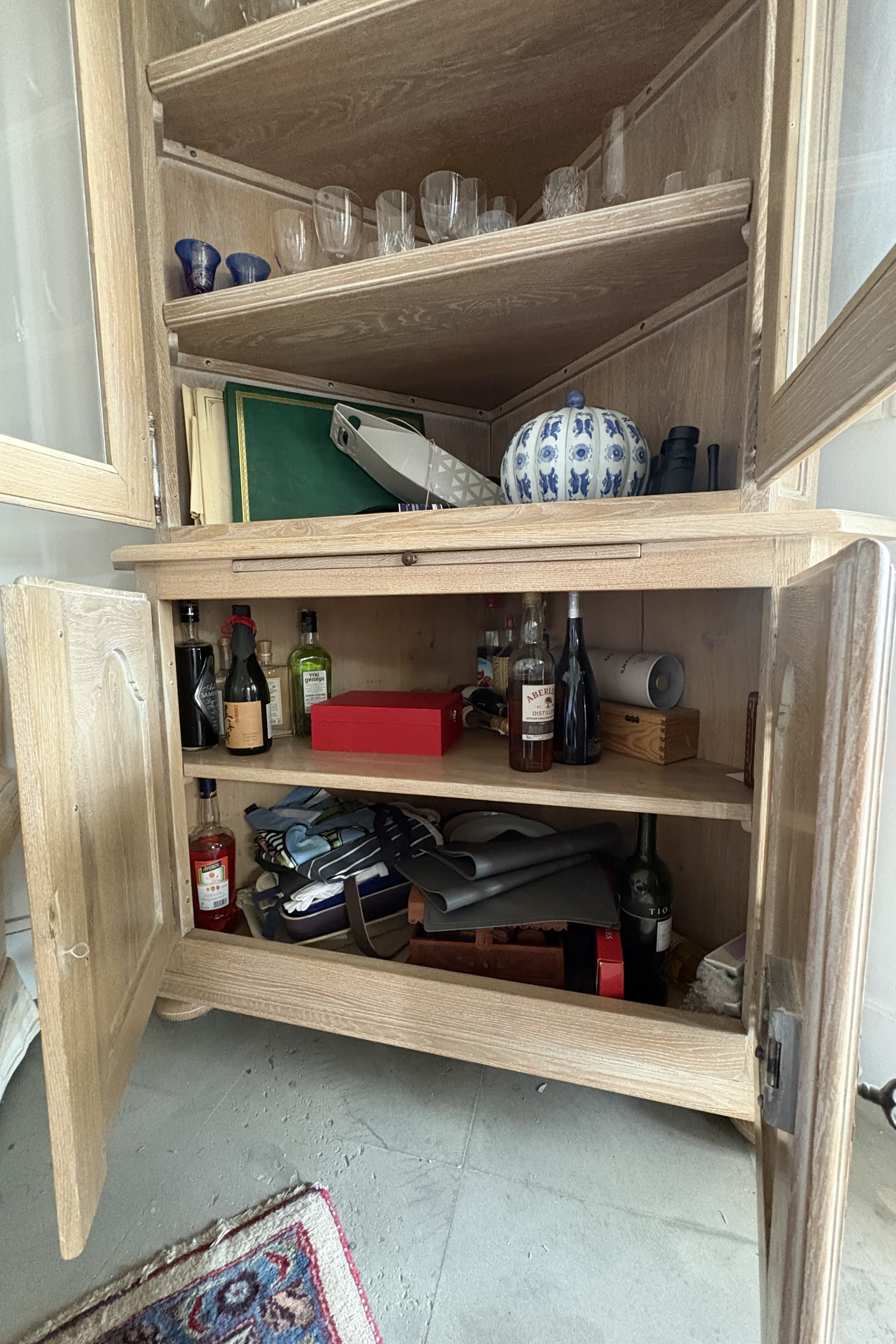 Solid ash corner drinks cabinet by Frances Bilham featuring glass doors and interior shelving for display and storage.