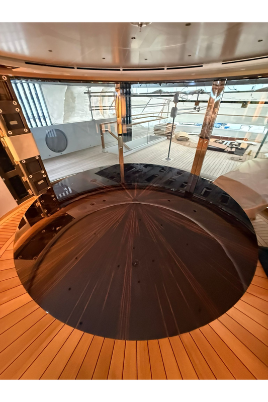 Custom yacht dining table by Ilyana Popova with a sleek round design, measuring 250 cm in diameter, perfect for luxurious marine dining.