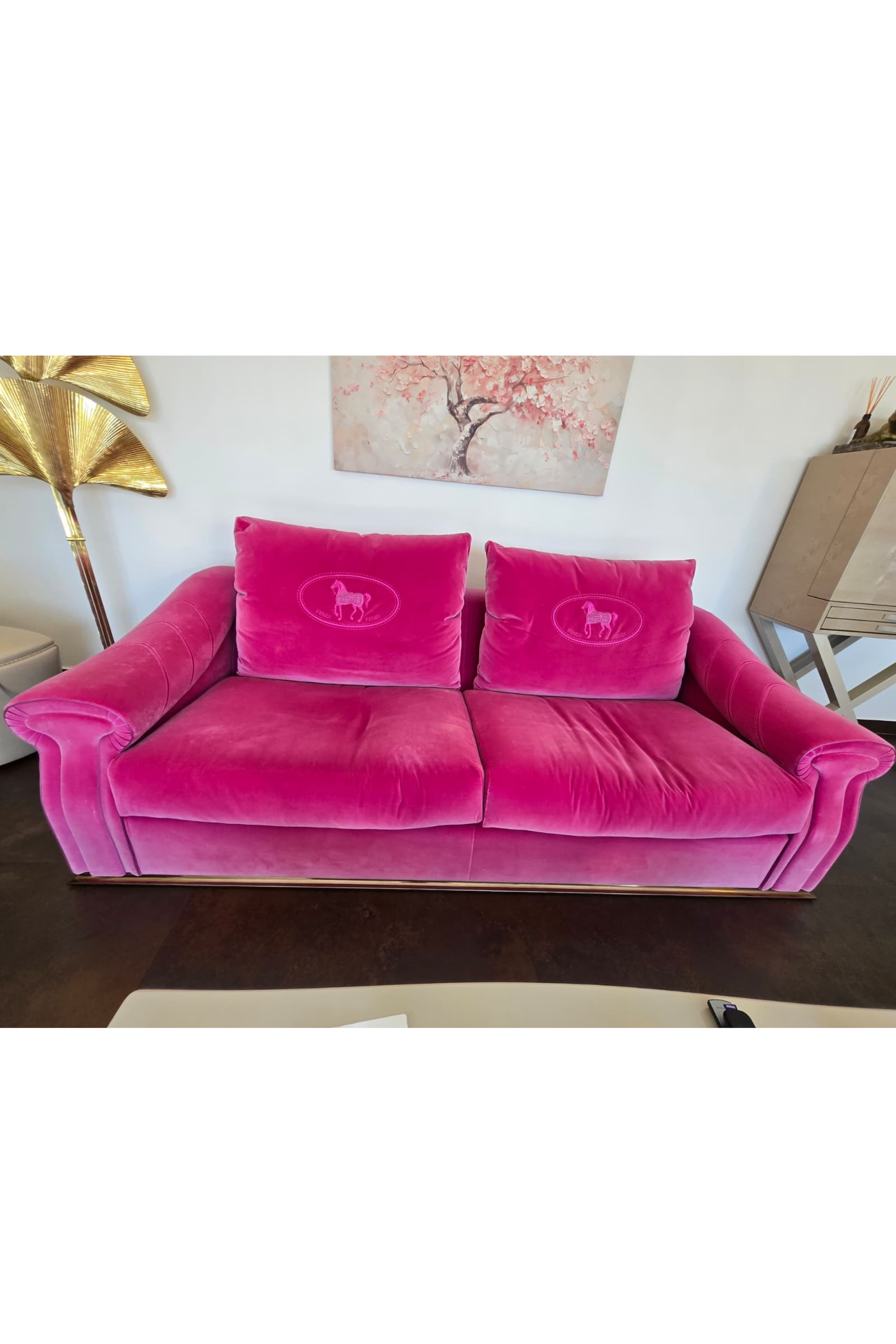 Pink Fendi Casa velvet sofa with sleek design, showcasing plush upholstery and modern style in a contemporary living space.