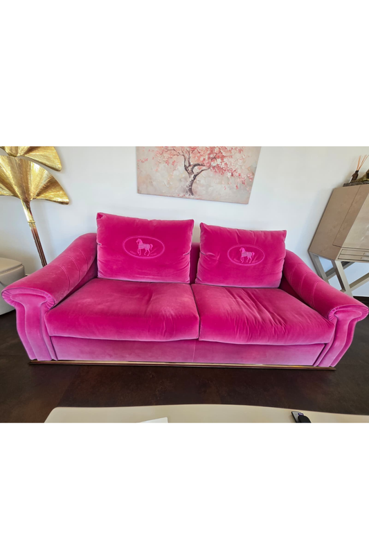 Pink Fendi Casa velvet sofa with sleek design, showcasing plush upholstery and modern style in a contemporary living space.
