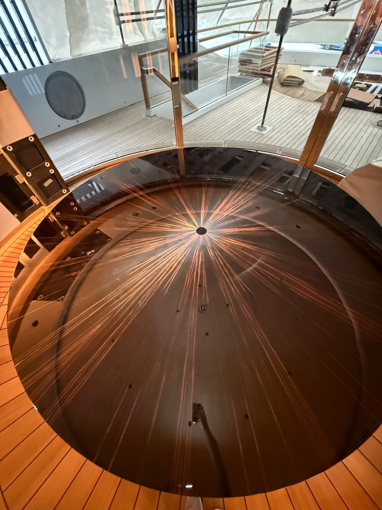 Custom yacht dining table by Ilyana Popova, round Ø250 cm, handcrafted wooden surface perfect for luxury boat interiors.