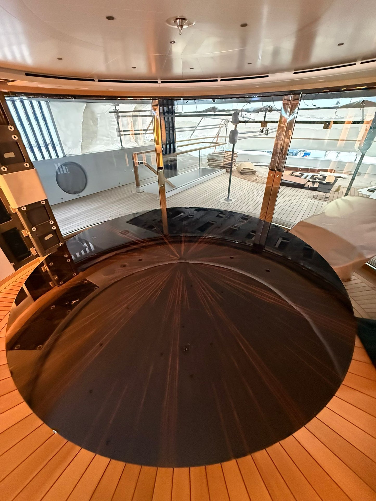 Custom yacht dining table by Ilyana Popova, round Ø250 cm, handcrafted wooden surface with elegant design for luxury yacht interiors.