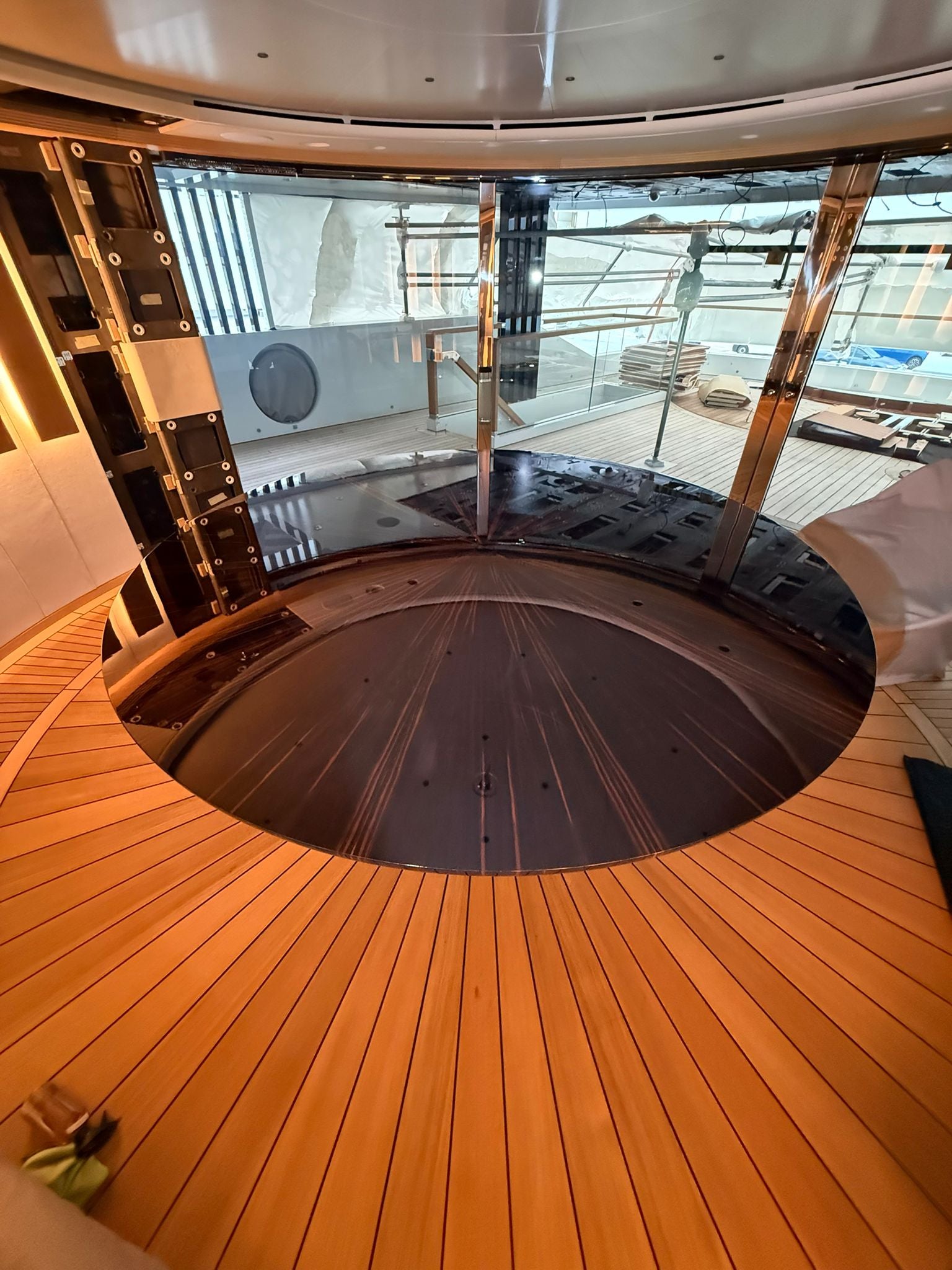 Custom yacht dining table by Ilyana Popova, 250 cm diameter, showcasing a bespoke design with polished wood surface and elegant craftsmanship.