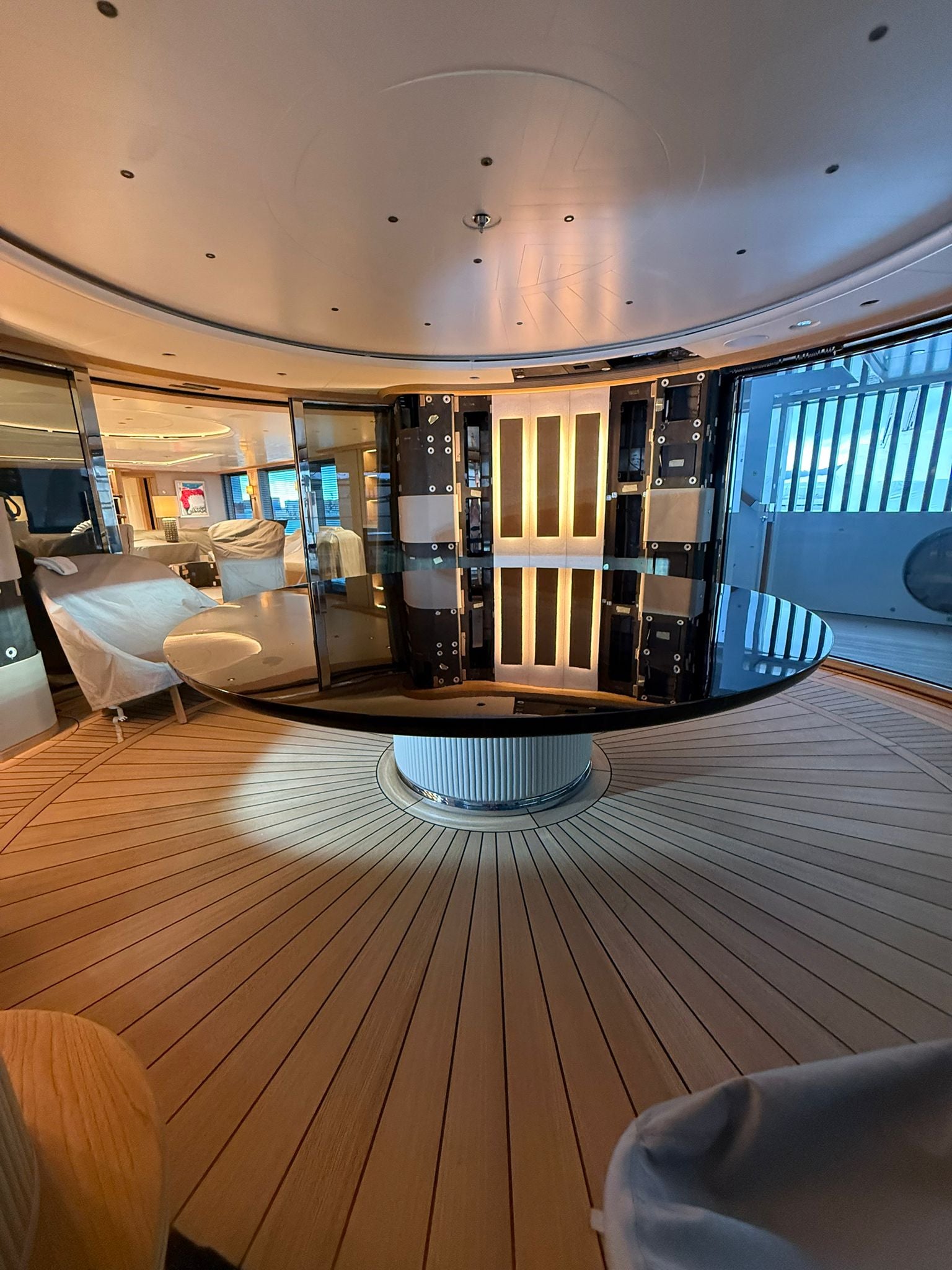 Custom yacht dining table by Ilyana Popova with a large circular Ø250 cm wooden surface and elegant bespoke design.