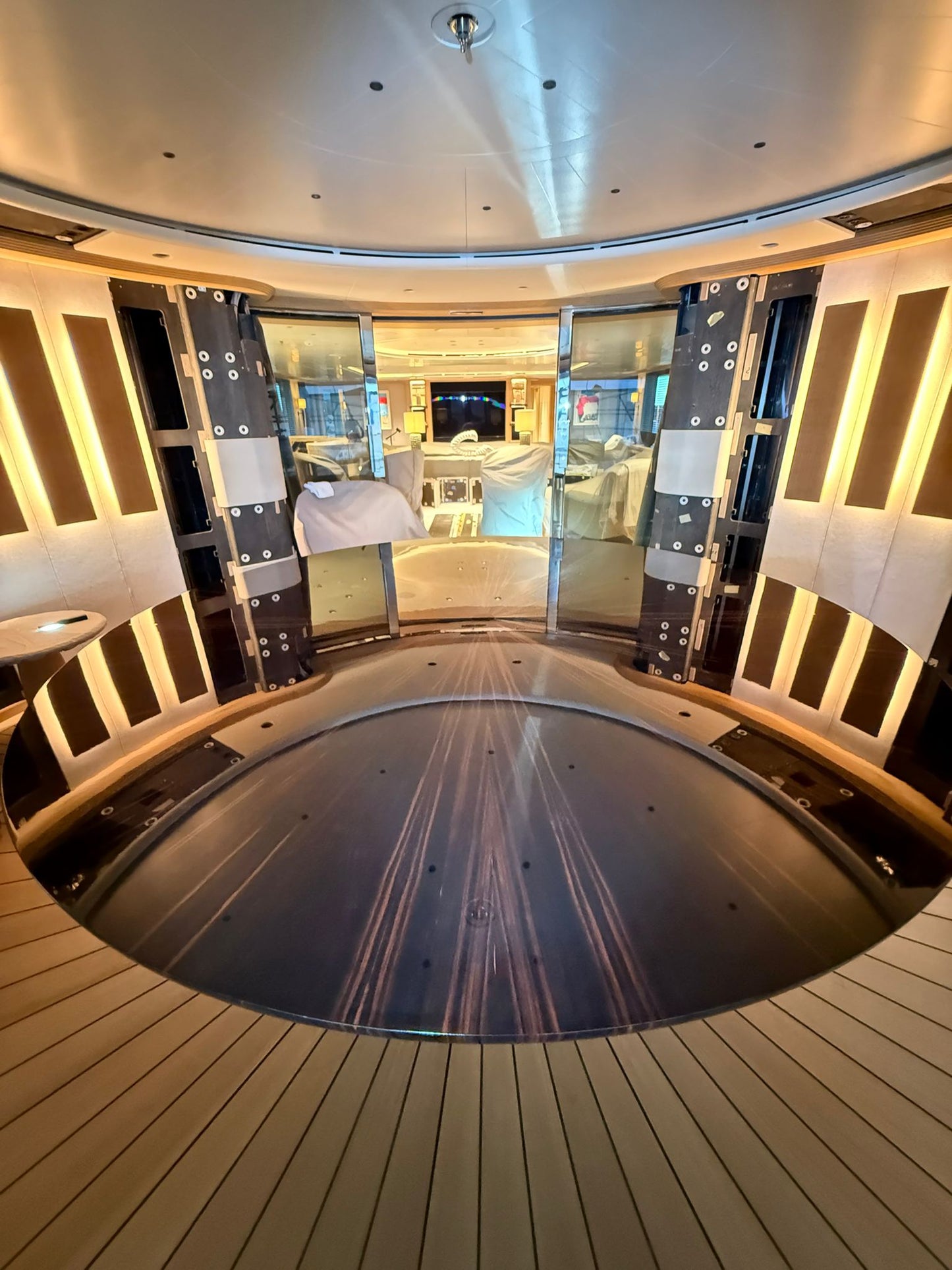 Custom yacht dining table by Ilyana Popova, large bespoke piece with a polished wooden surface and elegant design, Ø250 cm.