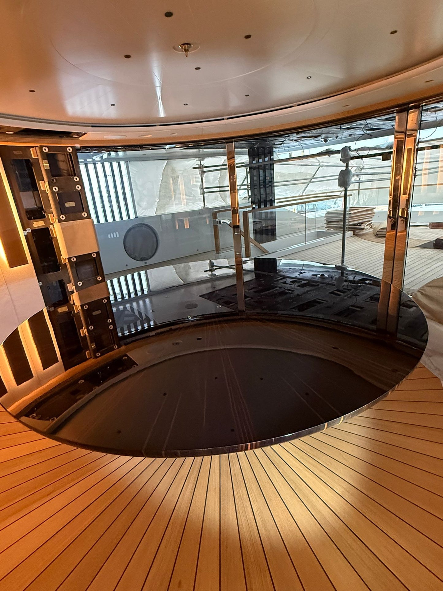 Custom yacht dining table by Ilyana Popova, 250 cm diameter, showcasing a sleek, bespoke wooden surface set on a luxurious yacht interior.