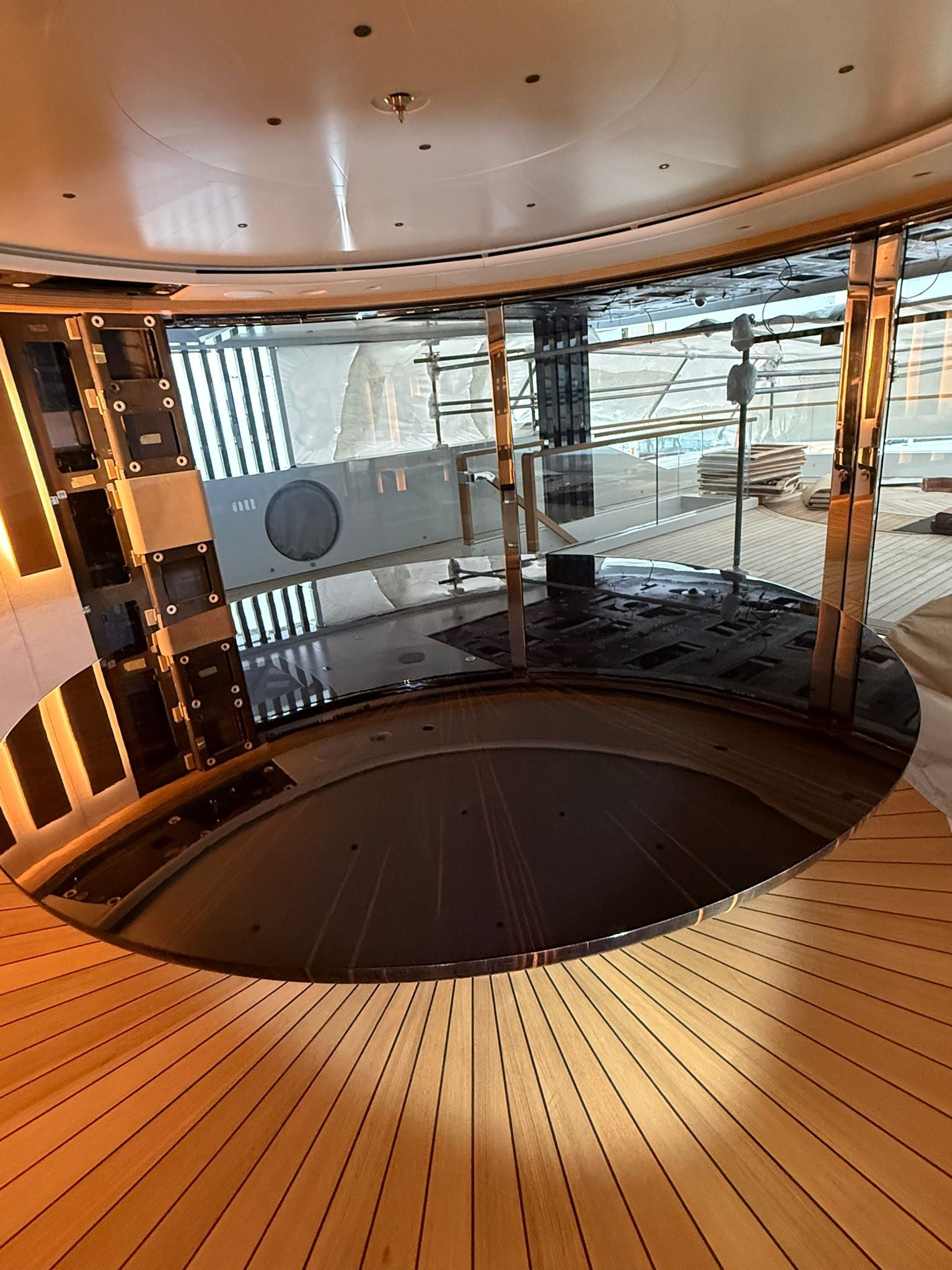 Custom yacht dining table by Ilyana Popova, 250 cm diameter, showcasing a sleek, bespoke wooden surface set on a luxurious yacht interior.