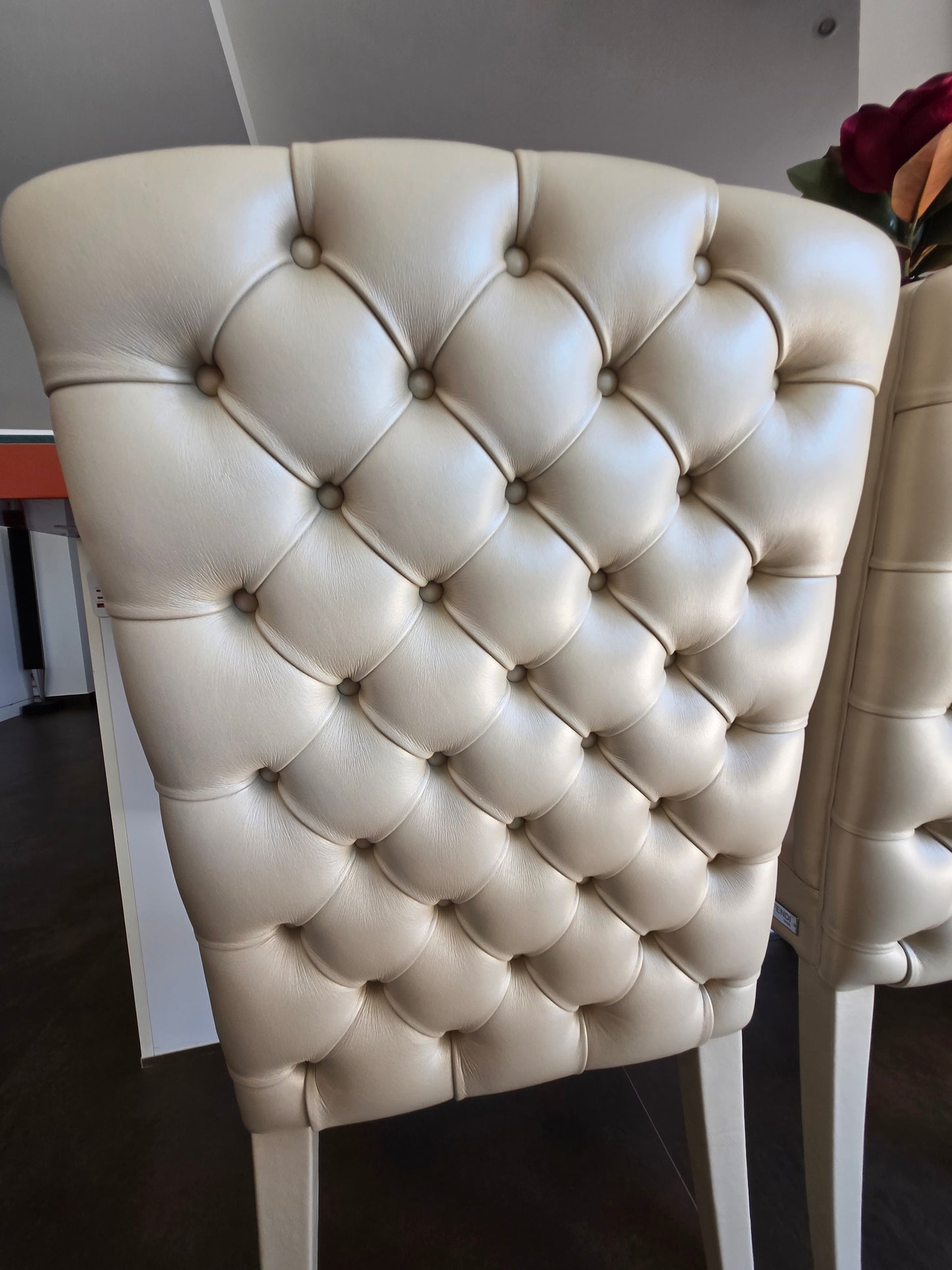 Marina Fogg Fendi Casa dining table with eight matching chairs, modern wood design, and sleek seating arrangement.