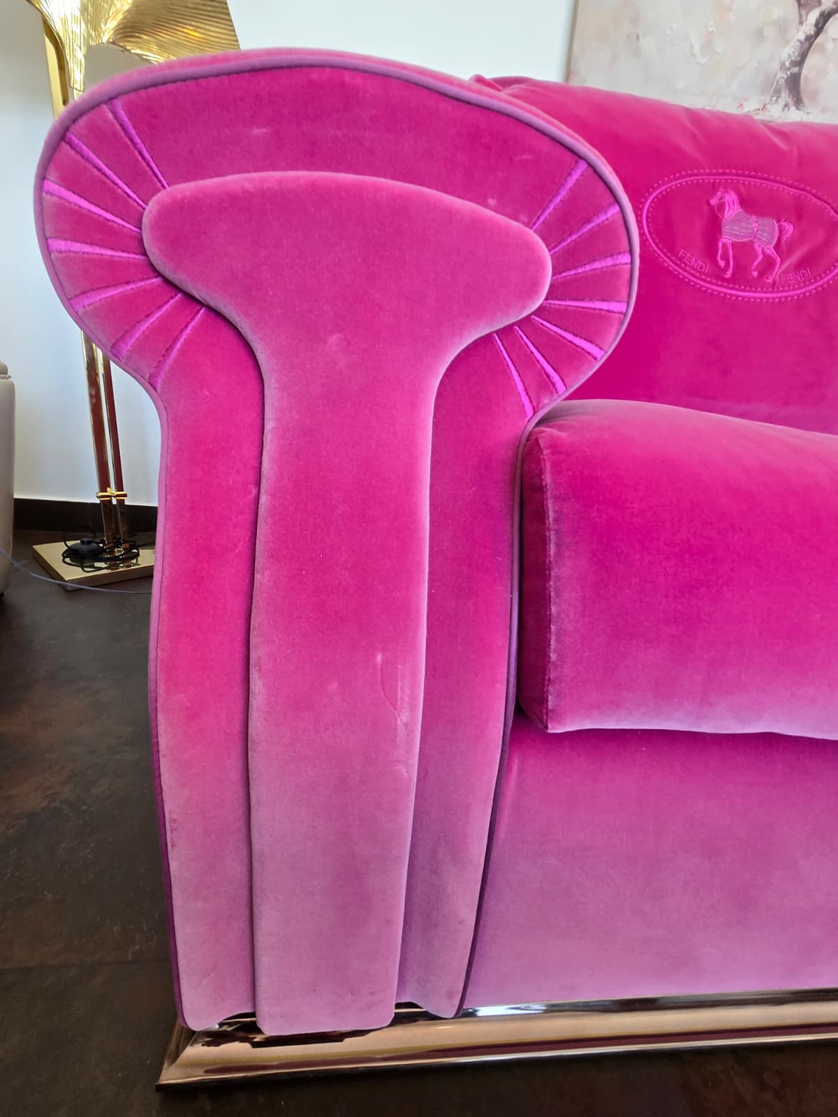 Pink velvet Fendi Casa sofa featuring plush upholstery and modern design, styled in a contemporary living room setting.