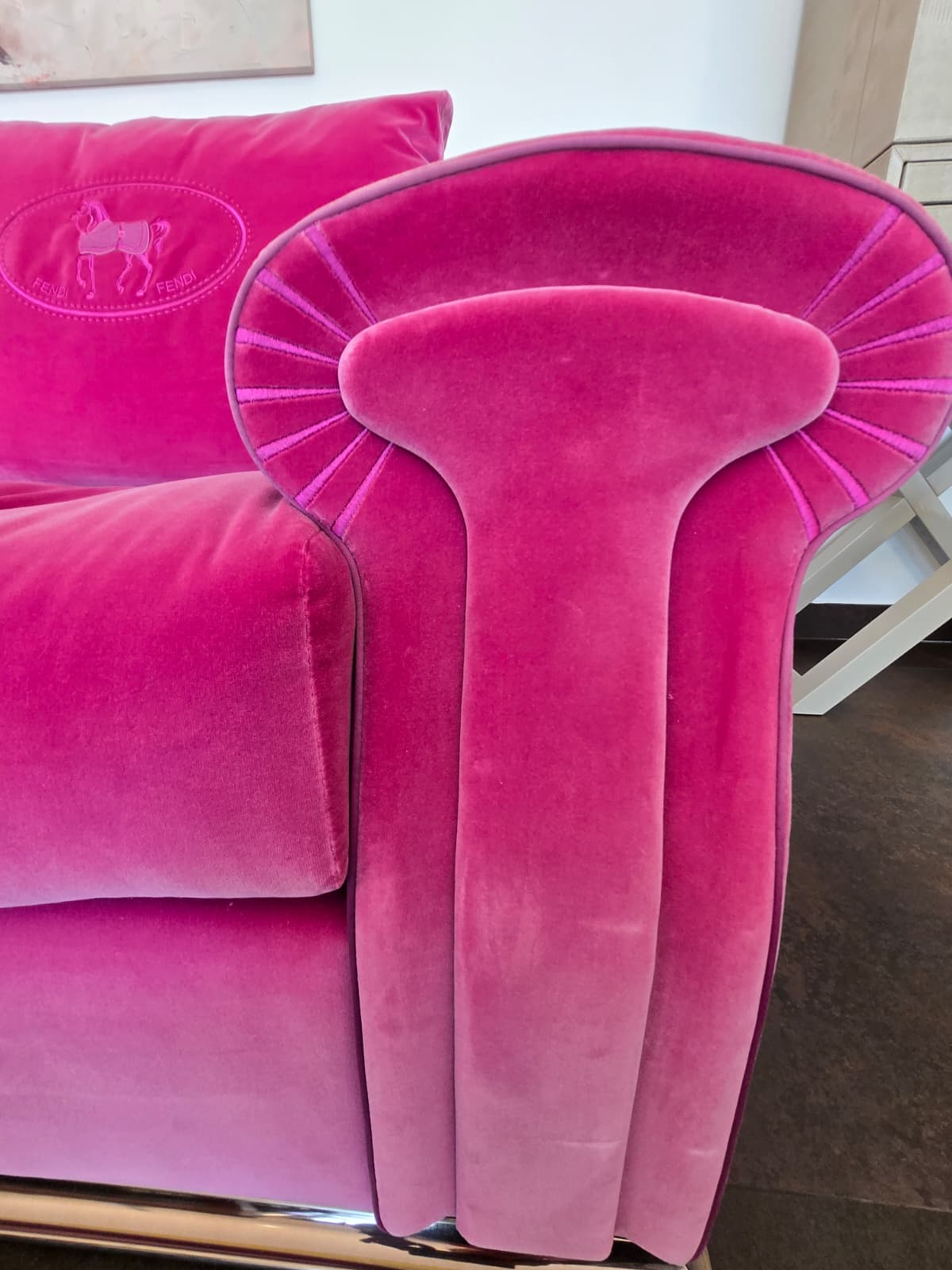 Pink velvet Fendi Casa sofa with sleek modern design, featuring plush cushions and stylish legs, showcased in a contemporary living space.