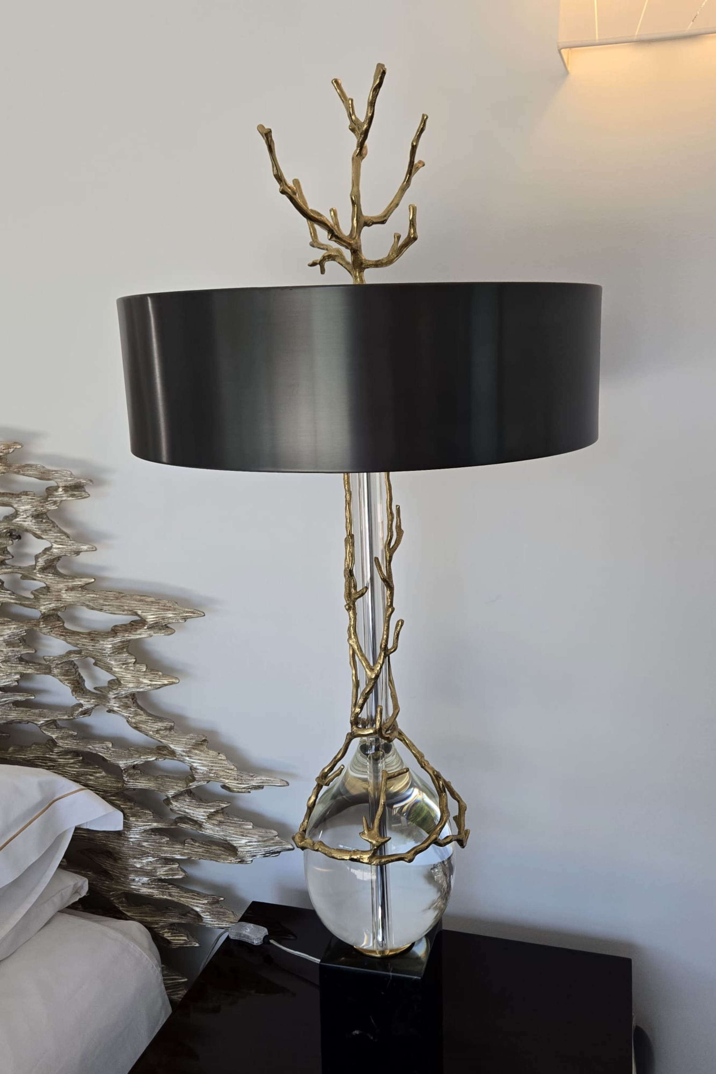 Pair of sculptural brass and glass table lamps with black metal shades by Marina Fogg, featuring artistic designs and modern style.