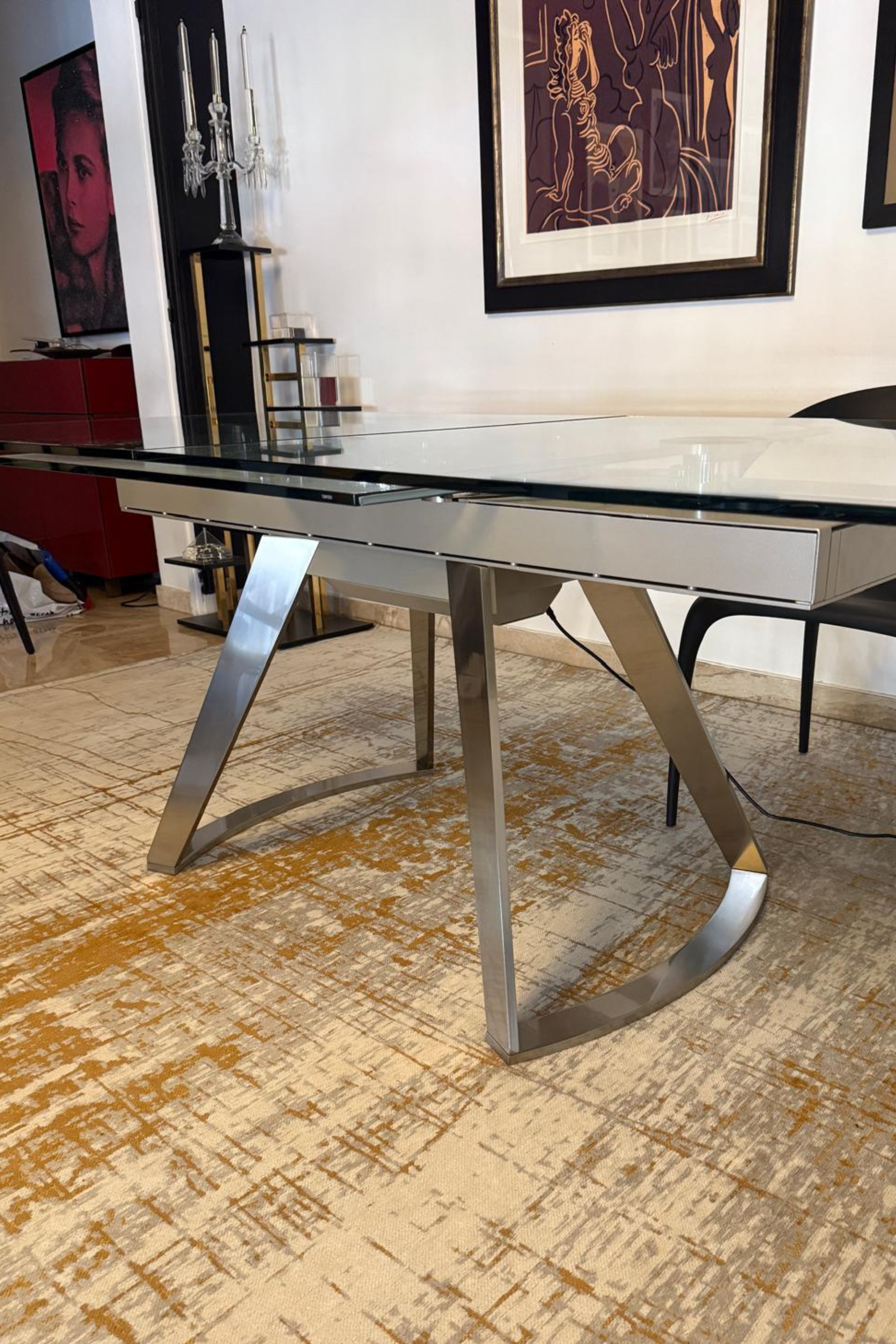 Roche Bobois Astrolab dining table in a modern dining room with sleek design and wooden finish, designed by Serpil Barrington-Serle.