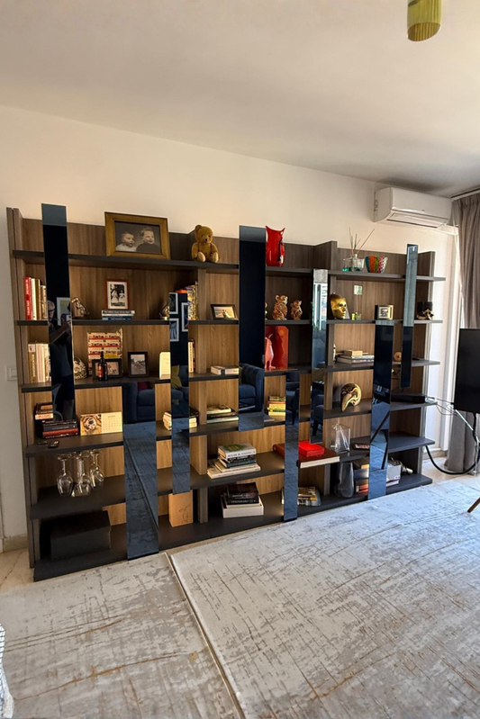 Roche Bobois Toccata bookshelf designed by Serpil Barrington-Serle, showcasing a modern wooden shelving unit with multiple compartments.