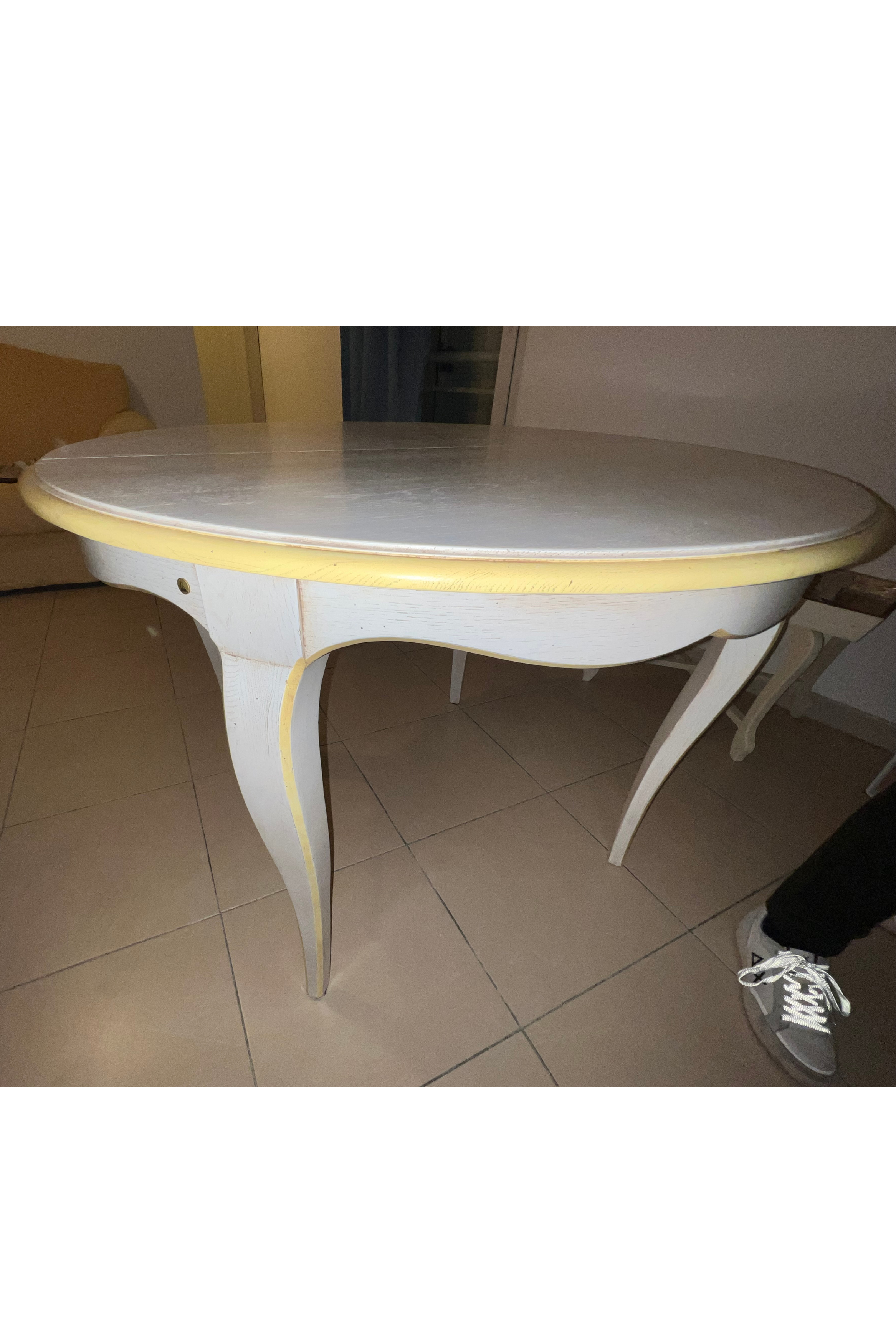White Luca Orrù table with matching chairs, modern dining set with sleek design and clean lines, placed in a contemporary interior setting.