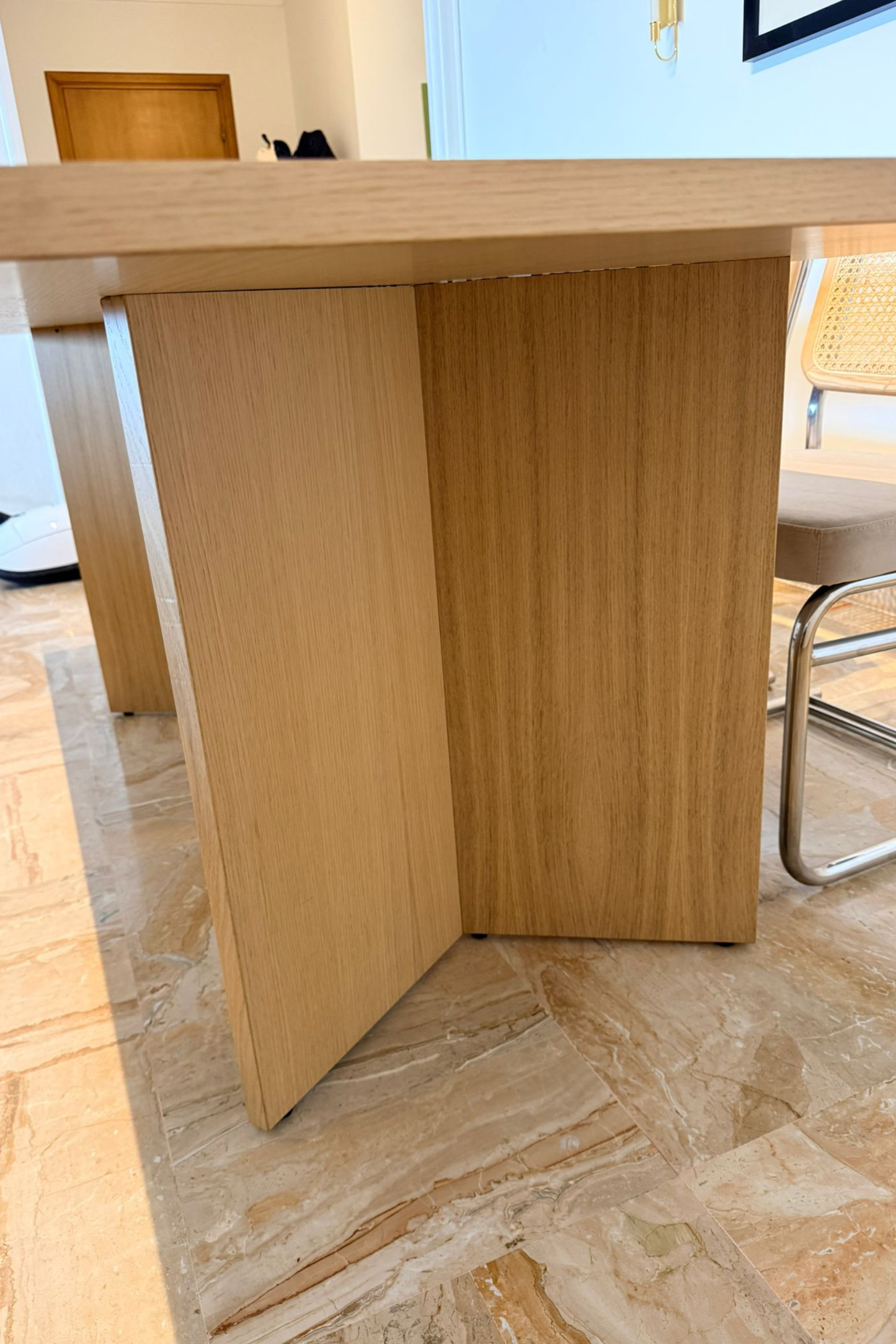 Wood veneer dining table by Charlotte Isackson with a sleek rectangular surface and modern design, shown from a side view.