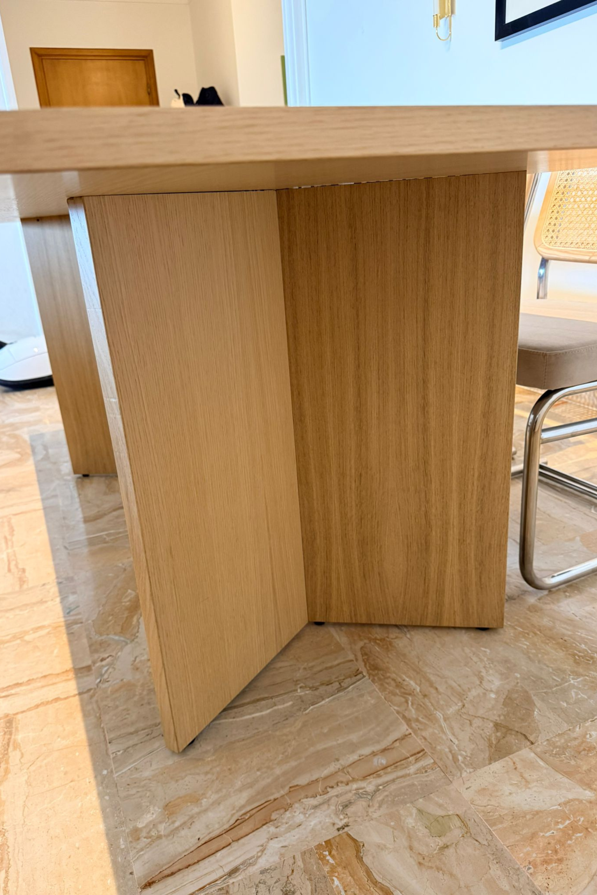 Wood veneer dining table by Charlotte Isackson with a sleek rectangular surface and modern design, shown from a side view.