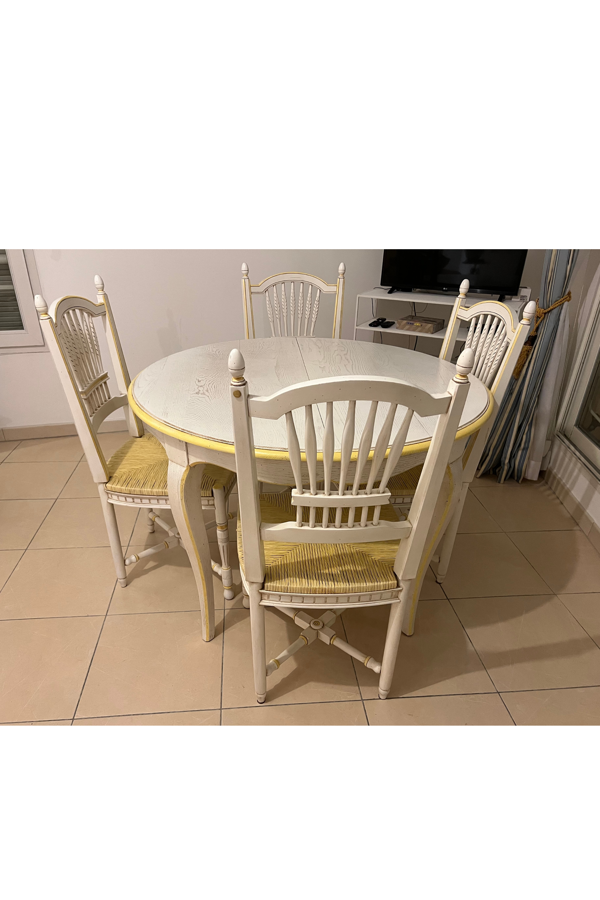 White Luca Orrù table with matching chairs set, featuring sleek modern design and smooth surfaces.