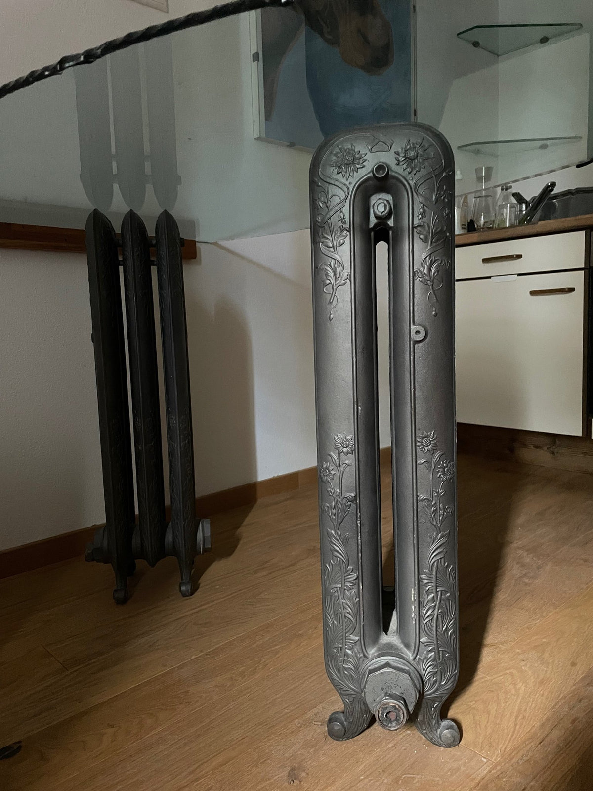 Close-up of the Art Nouveau cast-iron radiator base with relief flower decoration