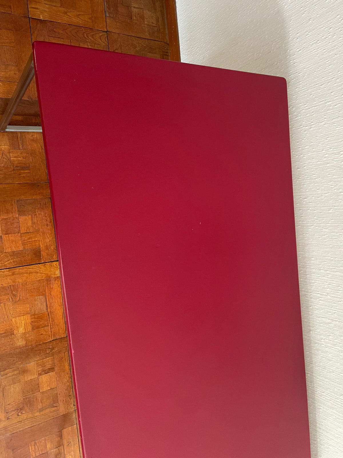 Close-up of the raspberry-red desk top surface